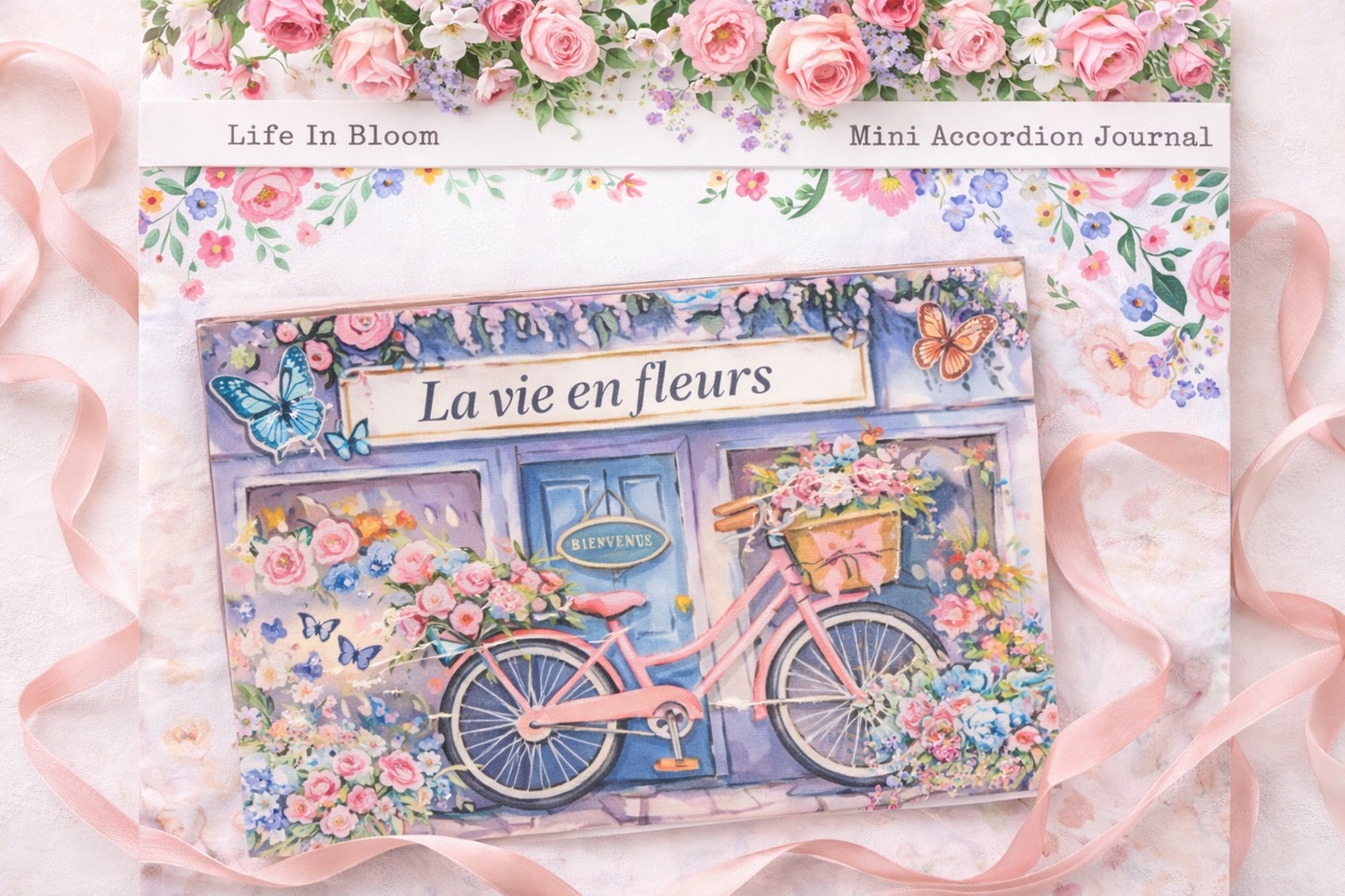 Romantic spring-themed mini accordion journal with pink roses, butterflies, and watercolor storefront artwork