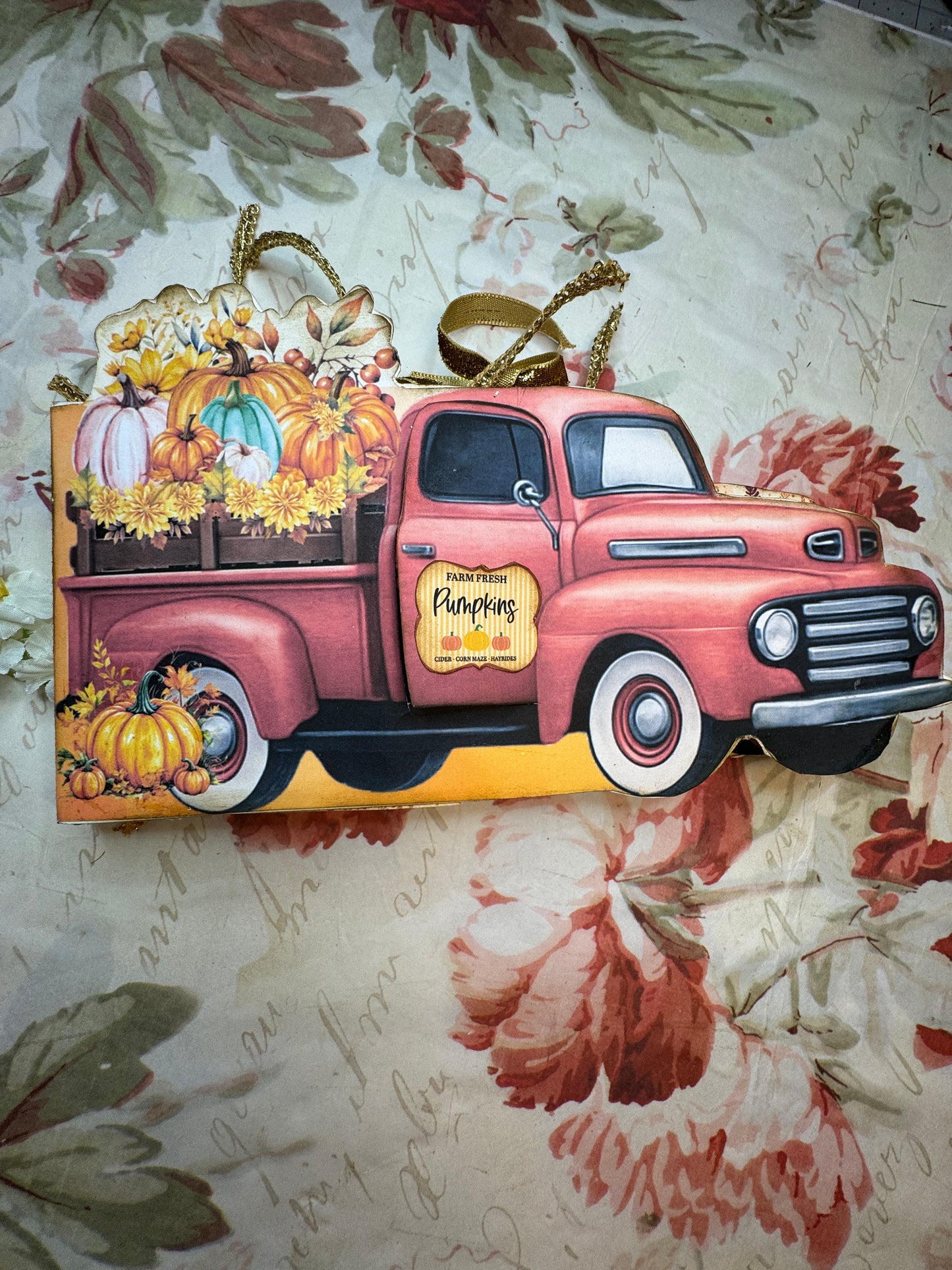 Front cover with vintage car design on a floral-patterned surface
