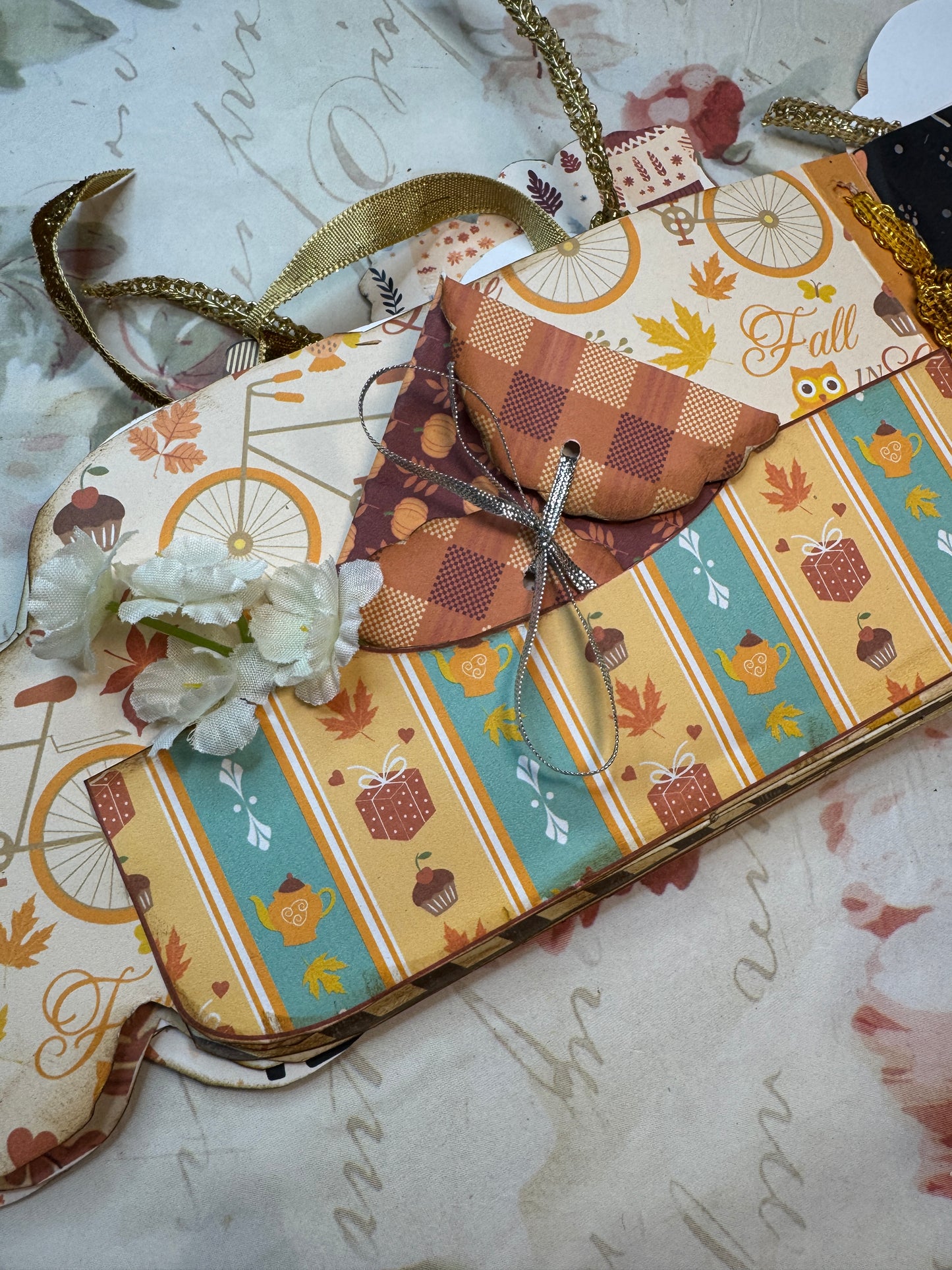 Decorative guitar case with autumn-themed pattern on a textured surface