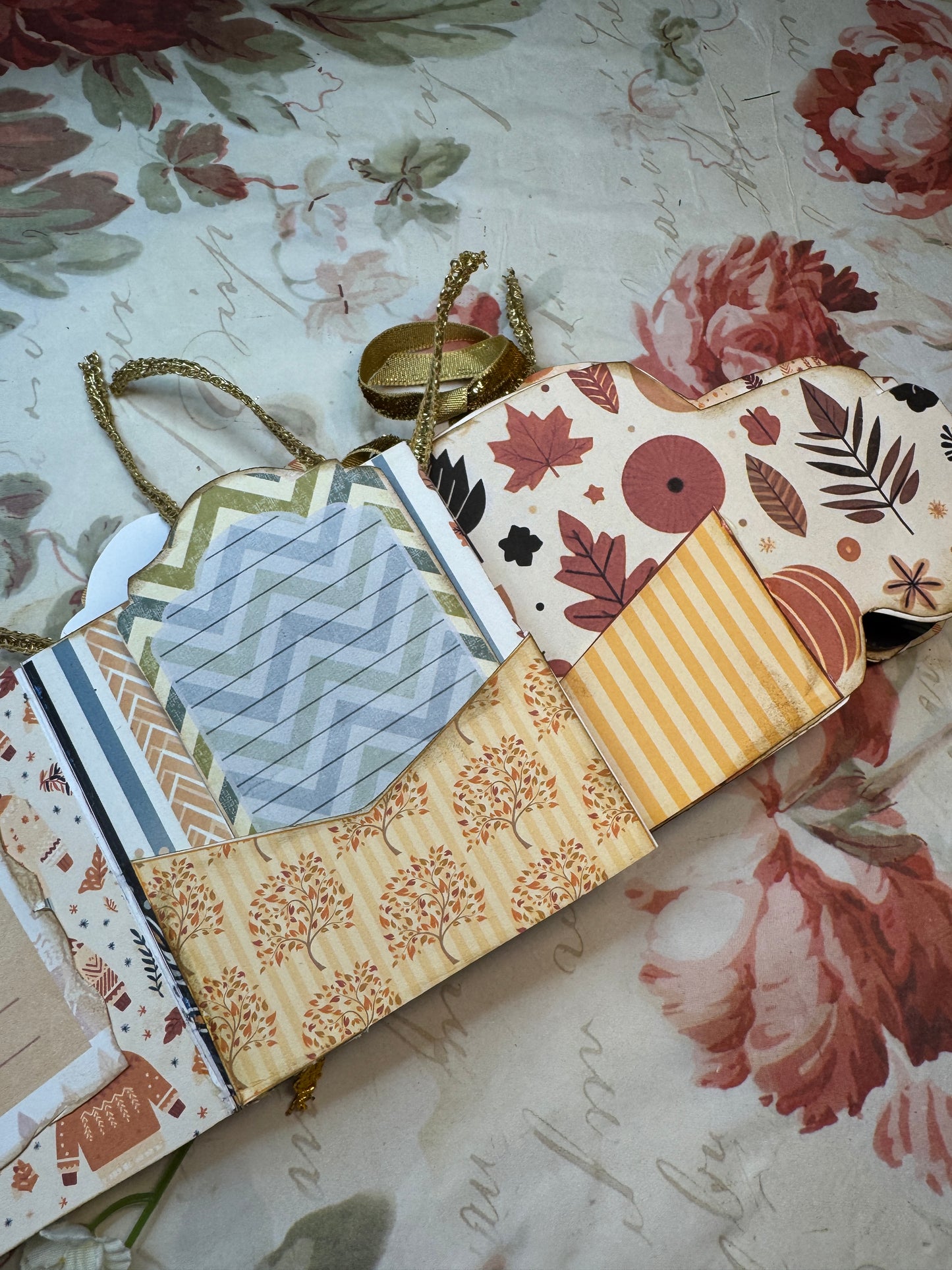 Collection of patterned paper sheets on a floral background