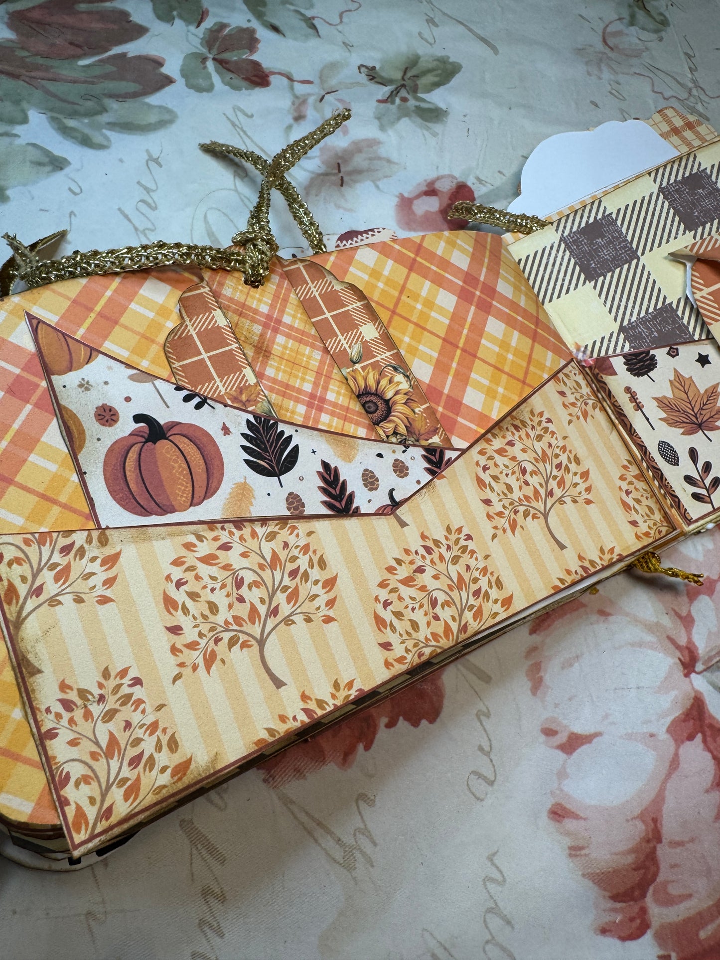 Decorative box with autumn-themed patterns on a textured surface