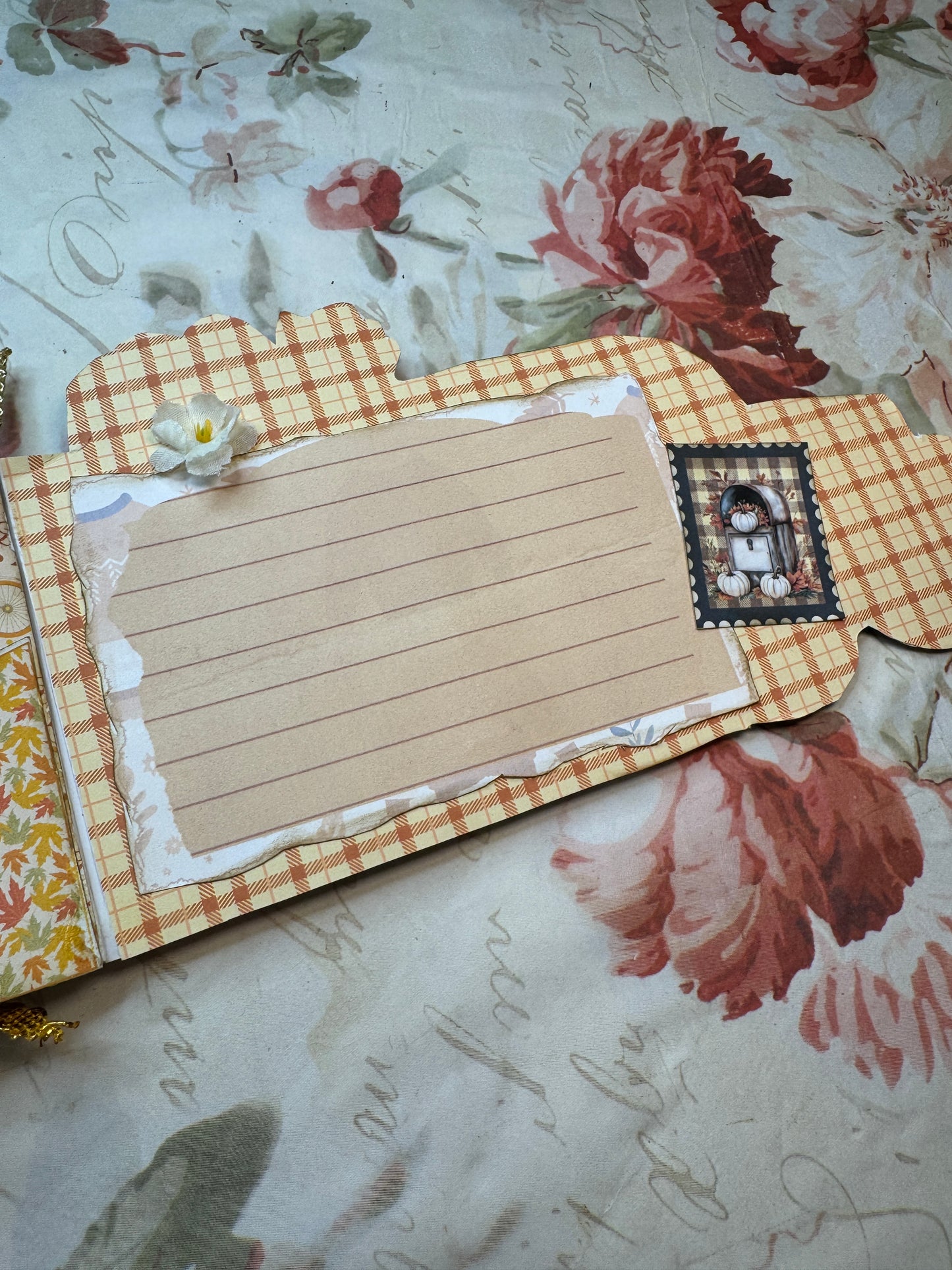 Decorative notepad with checkered border on a floral and script background