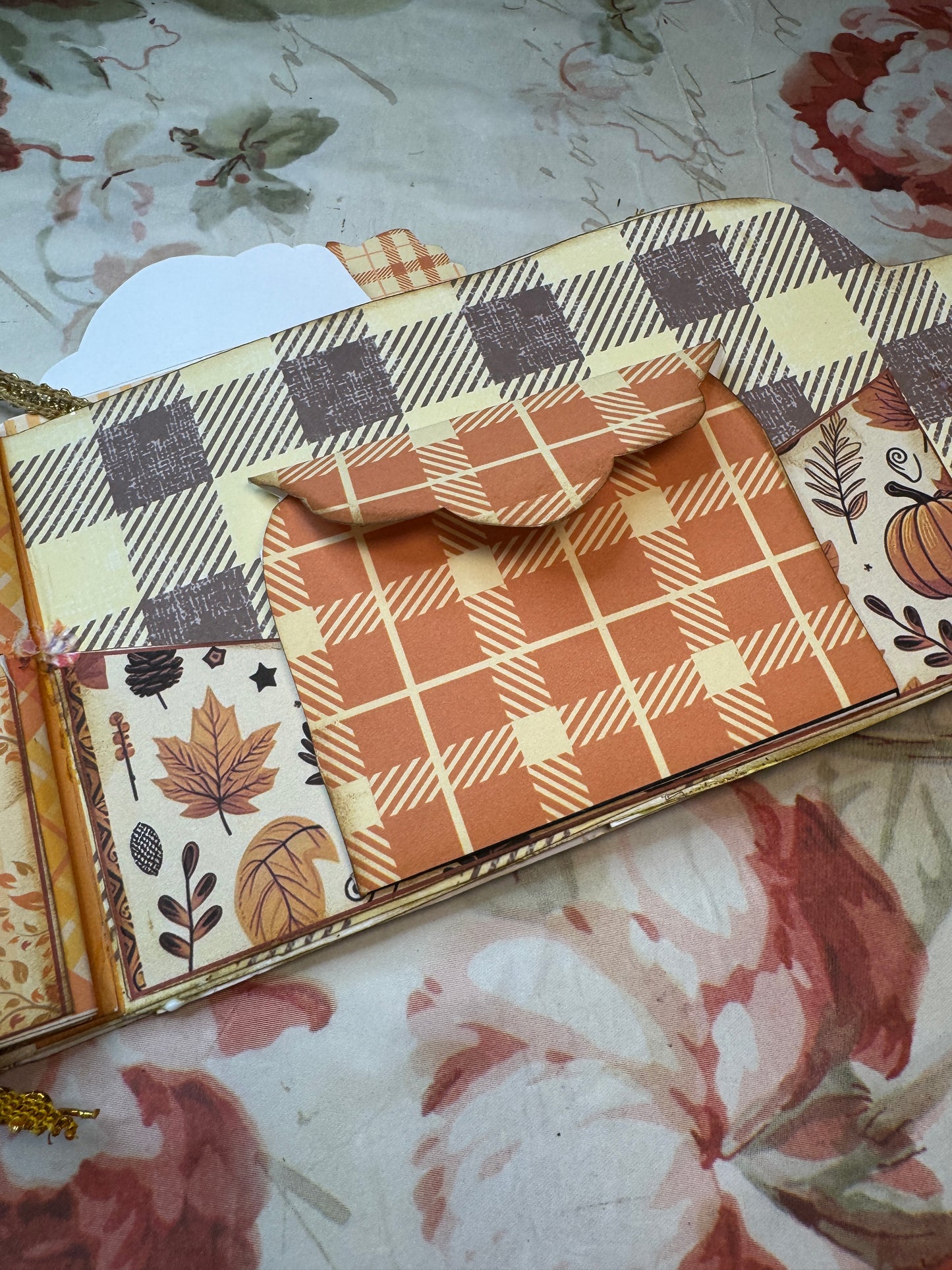 Decorative paper with autumnal patterns on a floral background