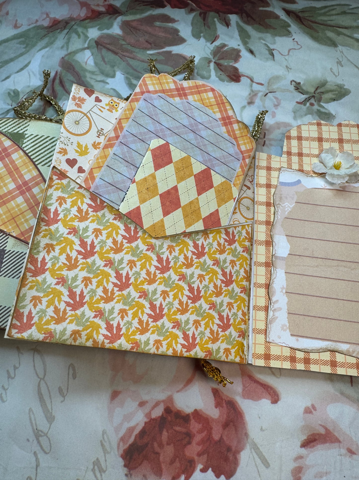 Decorative paper with autumnal patterns and textures on a floral background