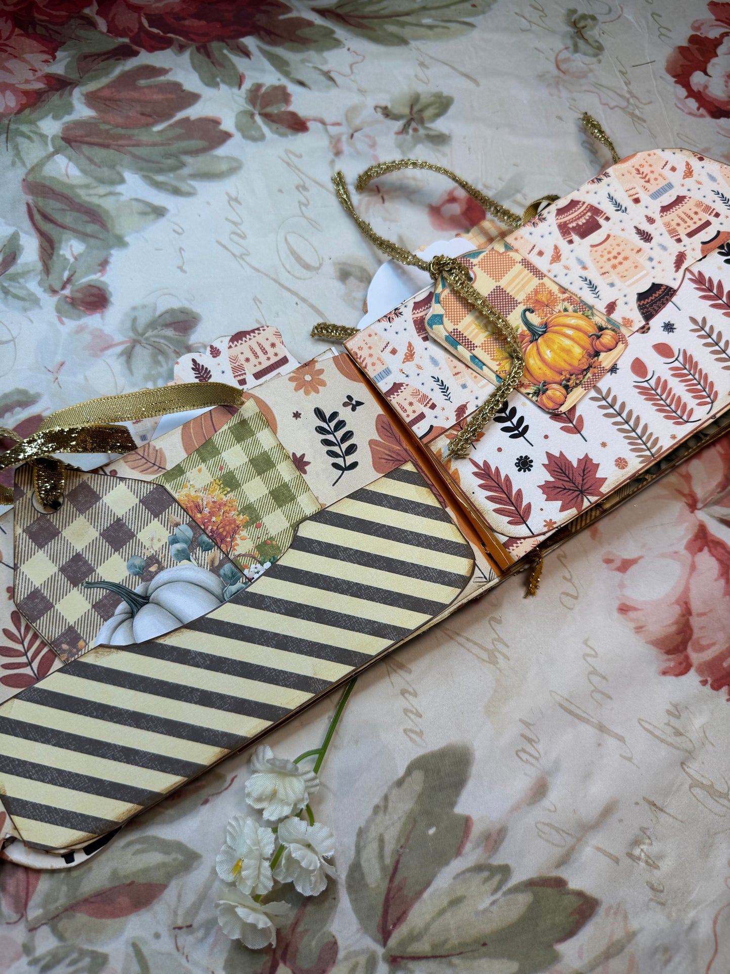 Decorative paper with autumn-themed designs on a floral background