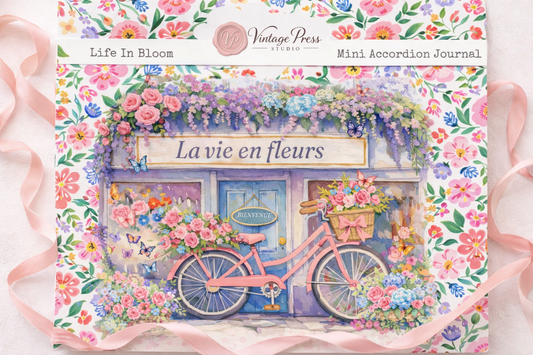 Floral cover design for Life’s in Bloom Mini Accordion Journal with pink bicycle and pastel flower shop scene