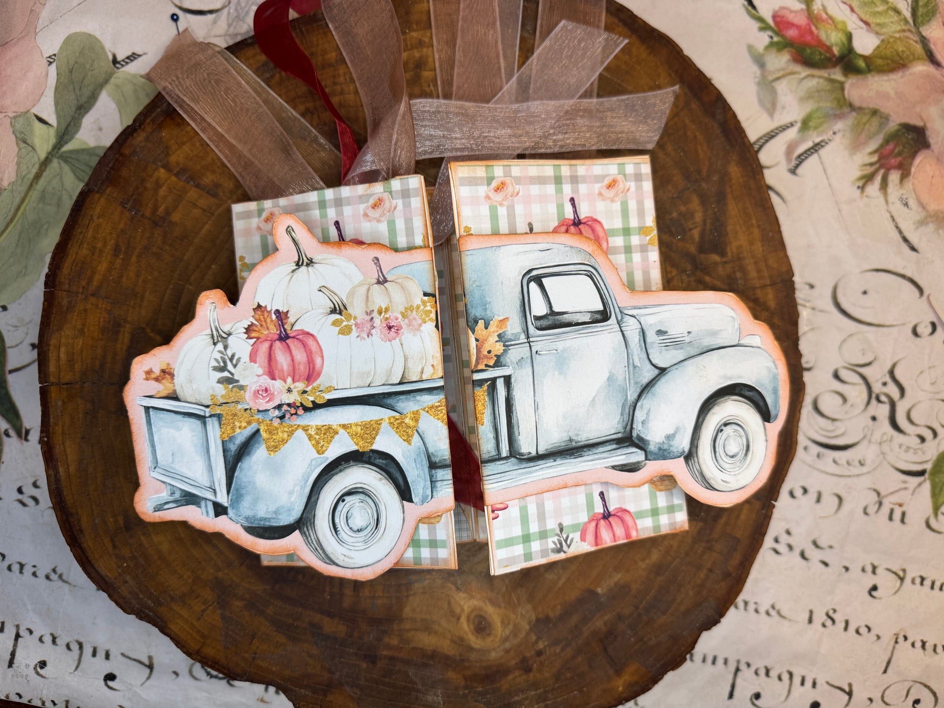 Closed 3D fall truck folio featuring pumpkins, flowers, and pastel plaid paper
