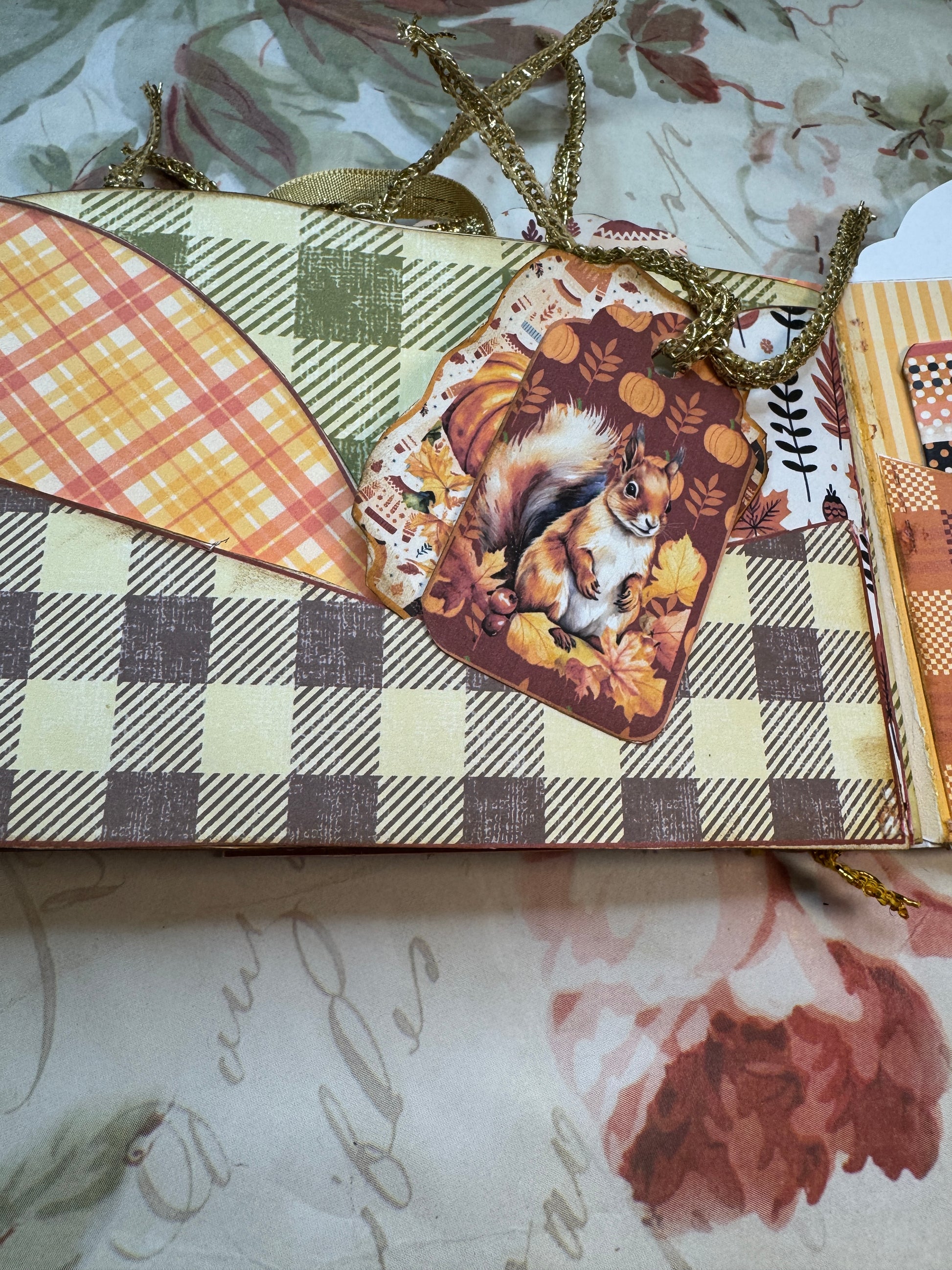 Decorative box with checkered pattern and animal illustration on a floral background