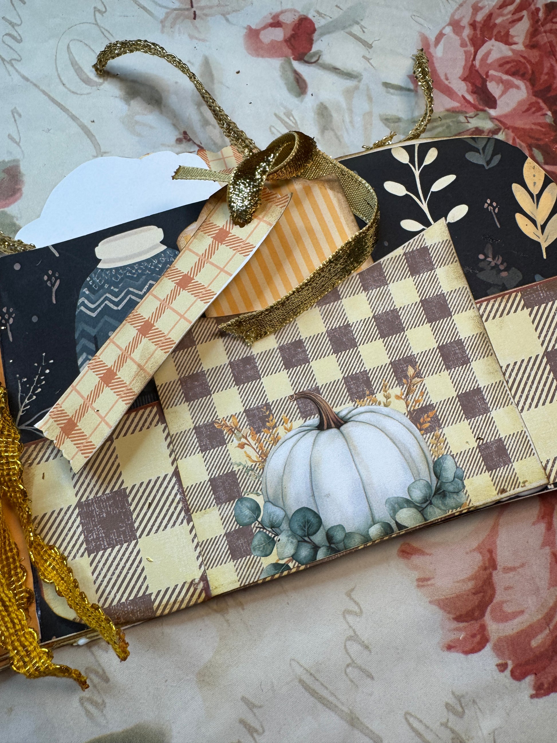 Decorative fabric swatches with pumpkins and checkered patterns on a textured background