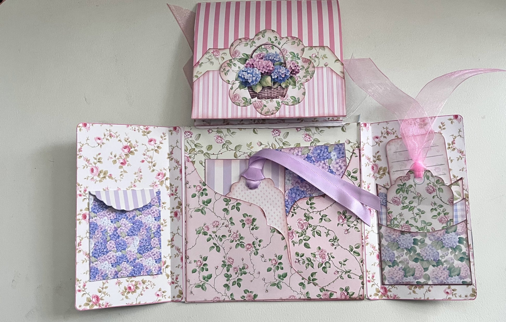 Le’ Gated Garden flip out folio opened showing fold-out panels, pockets, and journaling spaces in soft garden florals.