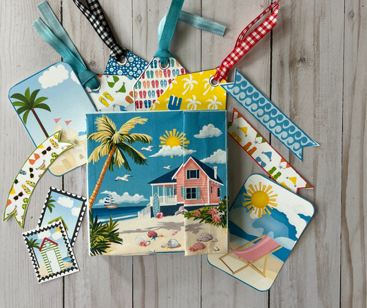 Life’s a Beach printable memory keeper folio kit featuring a pink beach house, palm trees, summer tags, bookmarks, and tropical ephemera for junk journaling, paper crafts and ribbons