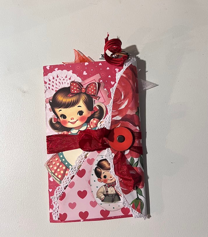 Assembled Valentine folio journal with pockets, lace trim, and charm dangles