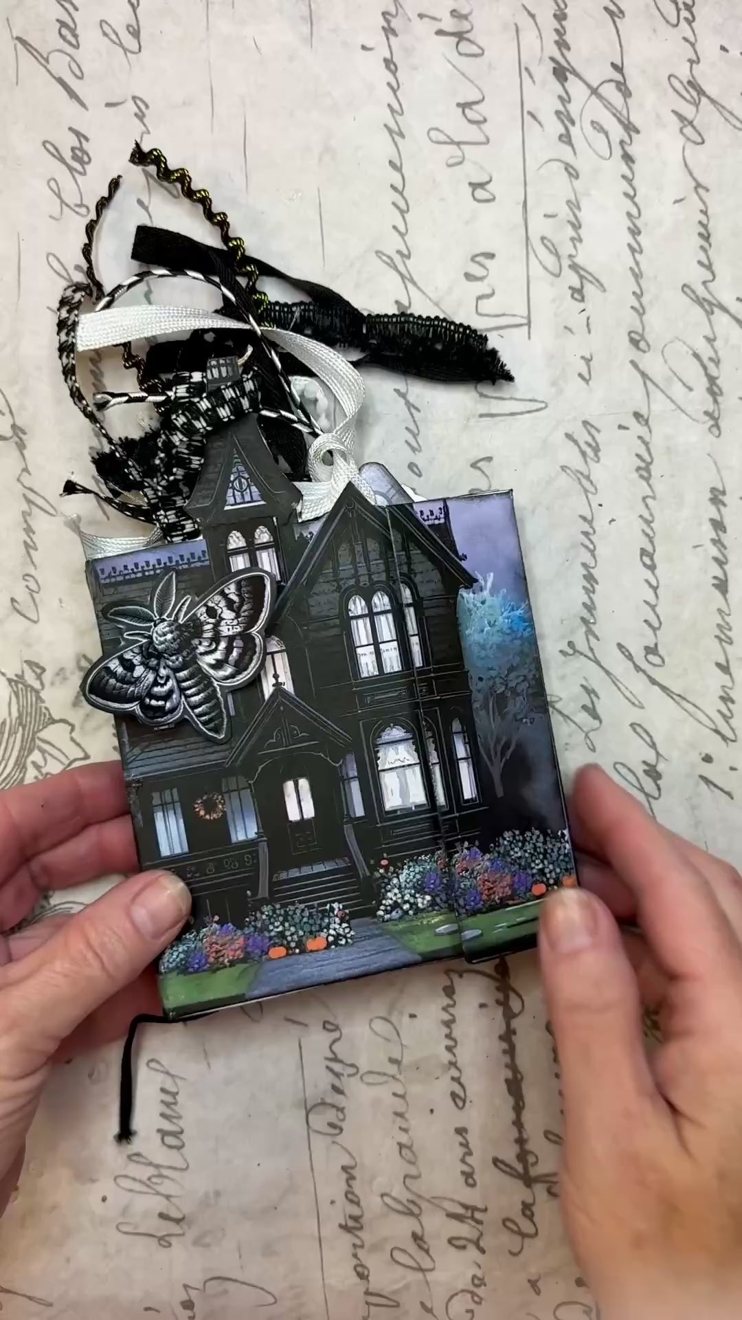 Video tutorial showing how to assemble the Twilight Manor Memory Keeper Halloween junk journal kit with printed folio pages, fussy cuts, and gothic embellishments