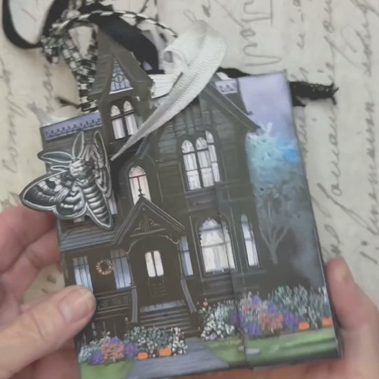 Video tutorial showing how to assemble the Twilight Manor Memory Keeper Halloween junk journal kit with printed folio pages, fussy cuts, and gothic embellishments