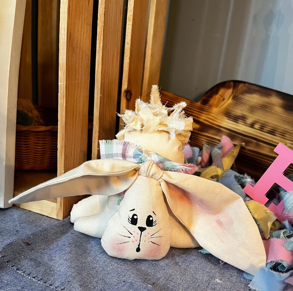 Muslin stuffed bunny with hand-painted face, three body tiers, floppy ears and rag tail